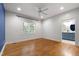 Well-lit bedroom with hardwood floors, featuring a window and an ensuite bathroom at 3359 Denise St, Durham, NC 27704