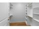 Walk-in closet with built-in shelving and wooden rods for optimal organization and storage at 3359 Denise St, Durham, NC 27704
