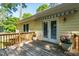 The wooden deck features double doors, an awning and potted plants at 3359 Denise St, Durham, NC 27704