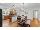 Bright dining area with a modern chandelier and adjacent kitchen at 3359 Denise St, Durham, NC 27704