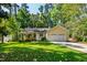 Charming yellow single-story home with a lush green lawn and mature trees at 3359 Denise St, Durham, NC 27704