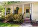 Inviting front porch with hanging ferns and classic white columns at 3359 Denise St, Durham, NC 27704