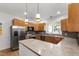 Renovated kitchen featuring stainless steel appliances, wooden cabinets, and ample counter space at 3359 Denise St, Durham, NC 27704