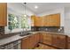 Bright kitchen featuring stainless appliances, light wood cabinets, and a view of the outdoor scenery at 3359 Denise St, Durham, NC 27704