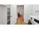 Modern laundry room with view into dining room, featuring new machines at 3359 Denise St, Durham, NC 27704