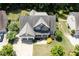Beautiful aerial view of a home with a large lot, mature trees, a two-car garage, and lush landscaping at 337 Shadowdale Ln, Rolesville, NC 27571