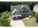 Overhead view of a home with a spacious driveway and landscaping, set in a neighborhood with mature trees at 337 Shadowdale Ln, Rolesville, NC 27571