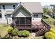 Inviting screened-in back porch and wooden deck overlooking a lush backyard at 337 Shadowdale Ln, Rolesville, NC 27571