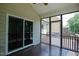 Cozy screened-in porch with dark wood floors, ceiling fan, and views of the backyard at 337 Shadowdale Ln, Rolesville, NC 27571