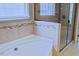 Bathroom features a walk-in shower, soaking tub, and tile surround at 337 Shadowdale Ln, Rolesville, NC 27571