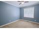Cozy bedroom with neutral carpet, ceiling fan, and a window providing natural light at 337 Shadowdale Ln, Rolesville, NC 27571