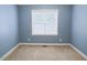 Neutral bedroom features carpeted floors and a window that allows plenty of natural light at 337 Shadowdale Ln, Rolesville, NC 27571