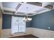 Dining room features a coffered ceiling, wainscoting, chandelier, and large window for natural light and elegant feel at 337 Shadowdale Ln, Rolesville, NC 27571