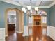 Arched entryway showcases elegant dining room with coffered ceiling and open living area with fireplace at 337 Shadowdale Ln, Rolesville, NC 27571