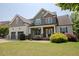 Charming home featuring a two-car garage, manicured lawn, stone accents, and lush landscaping for curb appeal at 337 Shadowdale Ln, Rolesville, NC 27571