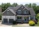 Charming two-story home featuring stone accents, a covered porch, and an attached two-car garage at 337 Shadowdale Ln, Rolesville, NC 27571