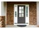 Elegant front door framed by stone and sidelights, welcomes you with style and natural light; black hardware at 337 Shadowdale Ln, Rolesville, NC 27571