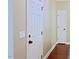 Hallway with freshly painted walls, white trim, wood floors, and white doors at 337 Shadowdale Ln, Rolesville, NC 27571