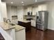 Spacious kitchen features granite countertops, stainless steel appliances, and a functional center island at 337 Shadowdale Ln, Rolesville, NC 27571
