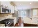 Open kitchen featuring stainless steel appliances, granite countertops, and hardwood floors, adjacent to dining area at 337 Shadowdale Ln, Rolesville, NC 27571