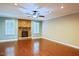 Spacious living room features a stone fireplace, hardwood floors, and natural light from large windows at 337 Shadowdale Ln, Rolesville, NC 27571