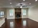 Spacious living room with stone fireplace, hardwood floors, recessed lighting, and two windows at 337 Shadowdale Ln, Rolesville, NC 27571