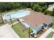 Aerial view of a community pool with lounge chairs and a pool house, perfect for summer fun at 337 Shadowdale Ln, Rolesville, NC 27571