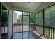 Relaxing screened porch with wooden floors offering a serene outdoor living space at 337 Shadowdale Ln, Rolesville, NC 27571