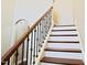 Elegant staircase with dark wood railing and white risers at 337 Shadowdale Ln, Rolesville, NC 27571
