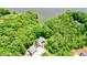 Aerial view of home featuring mature trees, a detached garage, and waterfront views at 3750 Mebane Rogers Rd, Mebane, NC 27302