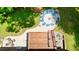 Aerial view of backyard brick house with a fire pit circled by chairs and wooden deck at 3750 Mebane Rogers Rd, Mebane, NC 27302