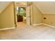 Spacious attic features neutral carpeting and view into the open floor plan at 3750 Mebane Rogers Rd, Mebane, NC 27302