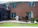 Back patio with a dining set, grill, gas heater, exterior access to a screened porch, and brick exterior at 3750 Mebane Rogers Rd, Mebane, NC 27302