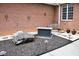 Backyard area with decorative rock, fire pit, a bench, and brick exterior walls at 3750 Mebane Rogers Rd, Mebane, NC 27302