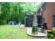 Backyard featuring a patio dining set, patio seating around a fire pit, a deck and a brick home exterior at 3750 Mebane Rogers Rd, Mebane, NC 27302