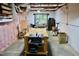 Spacious basement with a workbench, exposed ductwork, and pink insulation for projects or storage at 3750 Mebane Rogers Rd, Mebane, NC 27302