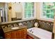 Bathroom featuring a soaking tub, granite countertops, vanity, and tiled walls at 3750 Mebane Rogers Rd, Mebane, NC 27302