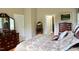 Bedroom with wood floors, a decorative headboard, wooden dressers, and natural lighting at 3750 Mebane Rogers Rd, Mebane, NC 27302