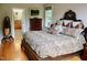 Comfortable bedroom with a decorative headboard, patterned bedding, and natural light at 3750 Mebane Rogers Rd, Mebane, NC 27302