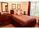 Comfortable bedroom showcasing warm colors, plush pillows, and decorative wall art at 3750 Mebane Rogers Rd, Mebane, NC 27302