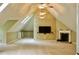 Bonus room with vaulted ceilings, fireplace, built-in shelving, and ample lighting at 3750 Mebane Rogers Rd, Mebane, NC 27302