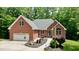 Charming brick home featuring an attached two-car garage and beautifully landscaped front yard at 3750 Mebane Rogers Rd, Mebane, NC 27302