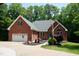 Charming brick home with well-manicured landscaping, an attached garage, and a circular driveway at 3750 Mebane Rogers Rd, Mebane, NC 27302