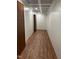 Well-lit hallway with wood floors and recessed lighting, connecting various areas of the home at 3750 Mebane Rogers Rd, Mebane, NC 27302