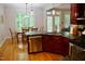 Kitchen featuring wooden cabinets, stainless steel appliances and a view of the dining area at 3750 Mebane Rogers Rd, Mebane, NC 27302