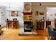 Open-concept living area features a stone fireplace, wooden bar, and access to the kitchen at 3750 Mebane Rogers Rd, Mebane, NC 27302