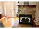 Cozy living room featuring a stone fireplace and hardwood floors near the entryway at 3750 Mebane Rogers Rd, Mebane, NC 27302