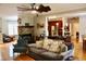 Inviting living room with stone fireplace, ceiling fan, hardwood floors, and access to kitchen at 3750 Mebane Rogers Rd, Mebane, NC 27302