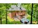 Rear exterior featuring large back deck, screened in porch and fire pit area at 3750 Mebane Rogers Rd, Mebane, NC 27302