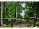 Secluded backyard deck featuring a relaxing seating area with a beautiful view of the lake at 3750 Mebane Rogers Rd, Mebane, NC 27302